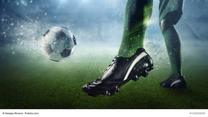 Foot of soccer player kicking ball. Mixed media attendorner geschichten - fussball